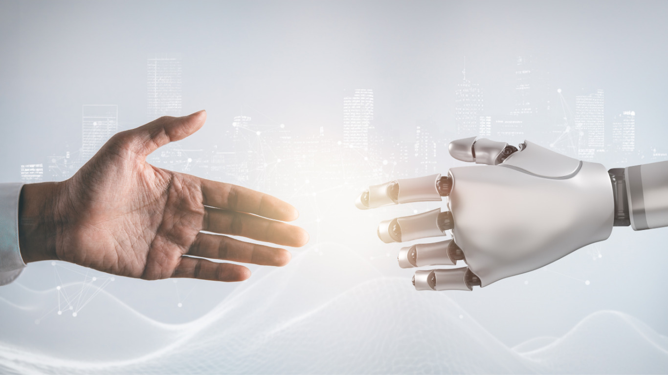 Menschliche Hand und Roboterhand reichen sich zur Zusammenarbeit – Symbolbild für Künstliche Intelligenz und menschliche Partnerschaft.